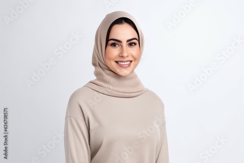 Portrait of beautiful muslim woman in hijab looking at camera and smiling
