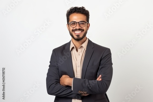 Portrait of a handsome young Indian businessman wearing glasses and smiling at camera