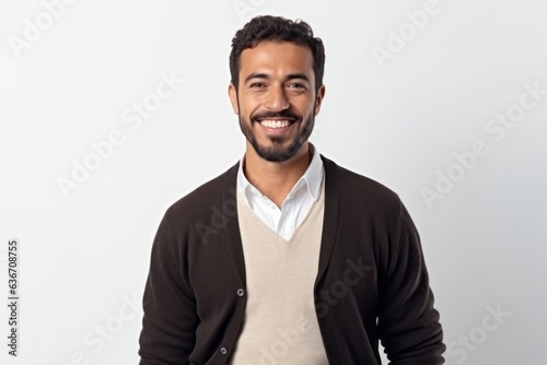 Portrait of handsome bearded Indian man in casual clothes smiling and looking at camera