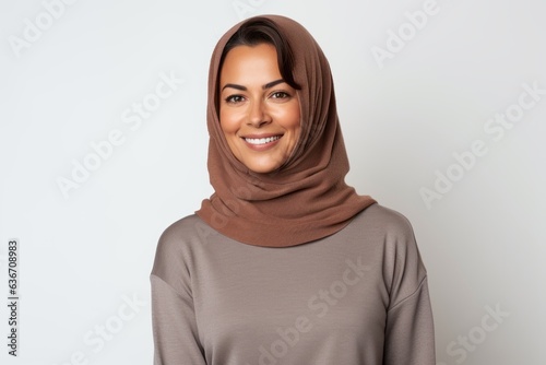 Portrait of a smiling muslim woman in hijab looking at camera