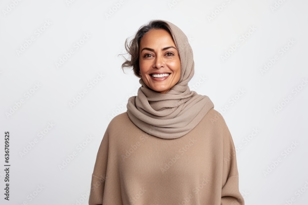 Portrait of a happy muslim woman in hijab looking at camera over white background