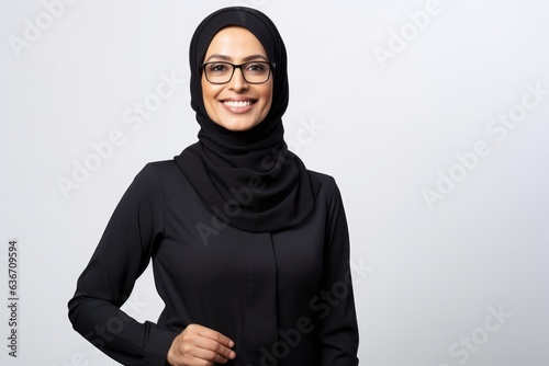 Portrait of smiling muslim woman in black hijab looking at camera