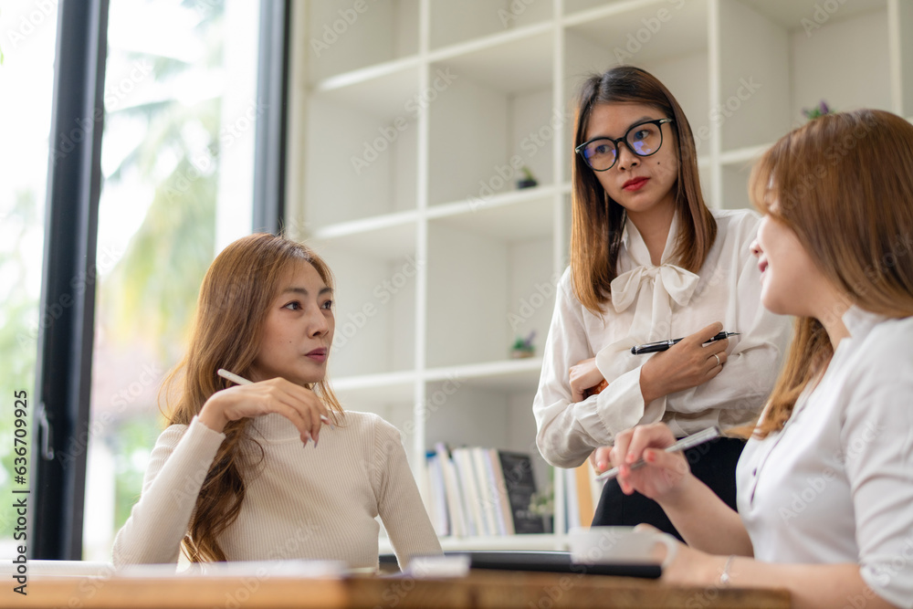 Businesswoman team brainstorming for upcoming projects.Consult and share ideas among colleagues Businesswoman team brainstorming for upcoming projects.Consult and share ideas among colleagues