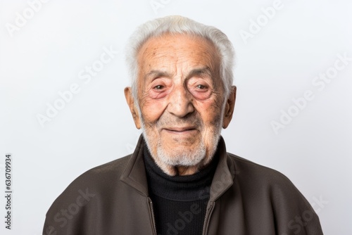 Portrait of a senior asian man looking at camera on white background © Anne-Marie Albrecht