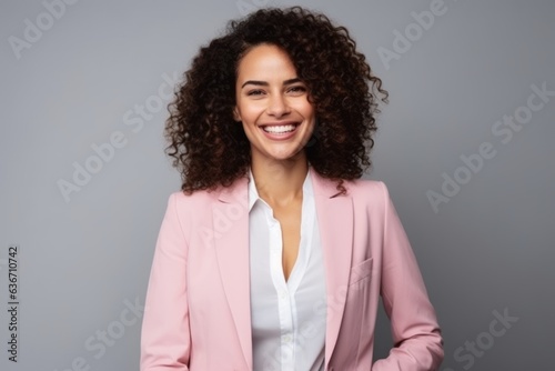 Portrait of a smiling young businesswoman standing isolated over gray background