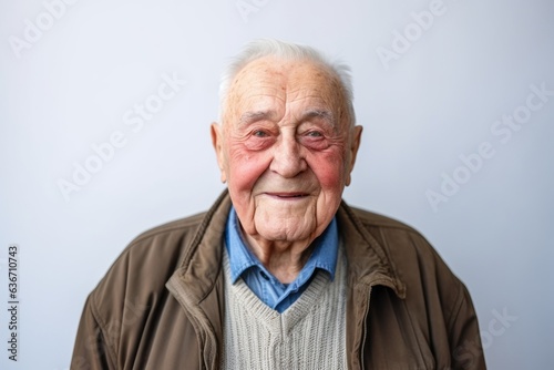 Portrait of an old man with wrinkles on his face, grey background © Anne-Marie Albrecht