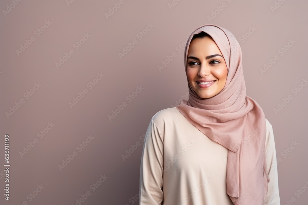 Portrait of a beautiful young muslim woman smiling at the camera. Portrait of a beautiful young muslim woman smiling at the camera.