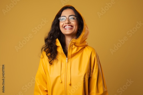 happy african american woman in yellow raincoat and eyeglasses © Anne-Marie Albrecht