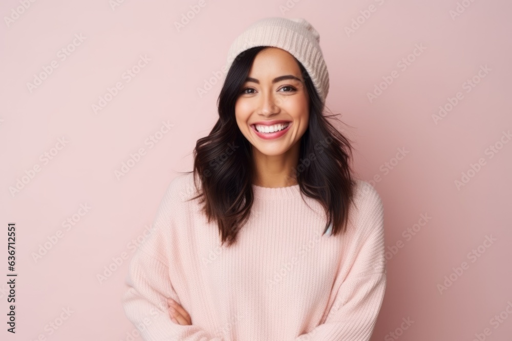Beautiful smiling young woman in a pink sweater and a hat on a pink background Beautiful smiling young woman in a pink sweater and a hat on a pink background