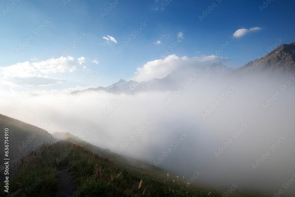 Beautiful morning mountain landscape with fog and road
