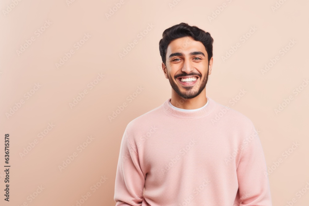 Portrait of a smiling young indian man isolated over beige background Portrait of a smiling young indian man isolated over beige background
