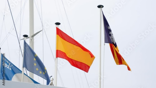 Catalonian and Spanish flags are waving photo