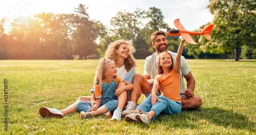 Happy family relaxing in the park photo