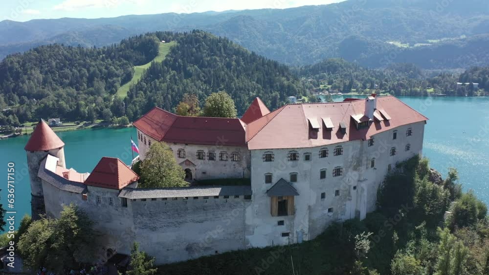 Aerial of Bled Castle or Blejski grad in Slovenia, with lake Bled in the foreground and the Karawanks Mountains. Summer. Drone video. Morning Aerial of Bled Castle or Blejski grad in Slovenia, with lake Bled in the foreground and the Karawanks Mountains. Summer. Drone video. Morning