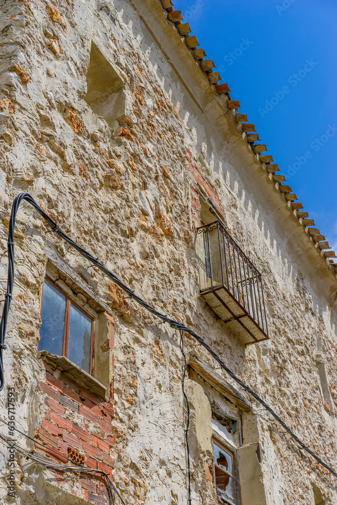 sunlit rural streets, traditional houses lining up, the essence of historic Spain captured
