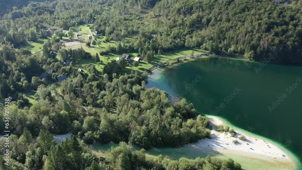 Lake Bohinj with European Alps in the background. Slovenia. Aerial. Summer. Tourists swim in kayaks. Lake Bohinj with European Alps in the background. Slovenia. Aerial. Summer. Tourists swim in kayaks.