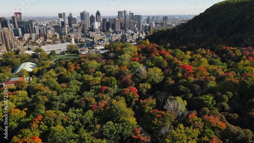 Aerial view of road in old district in Montreal. Drone footage of city, Montreal, Canada at autumn. Downtown cityscapes. View of Mont Royal mountain park.  Drone footage on sunset.