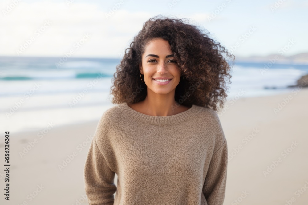 Medium shot portrait of a Brazilian woman in her 30s in a beach background wearing a cozy sweater Medium shot portrait of a Brazilian woman in her 30s in a beach background wearing a cozy sweater