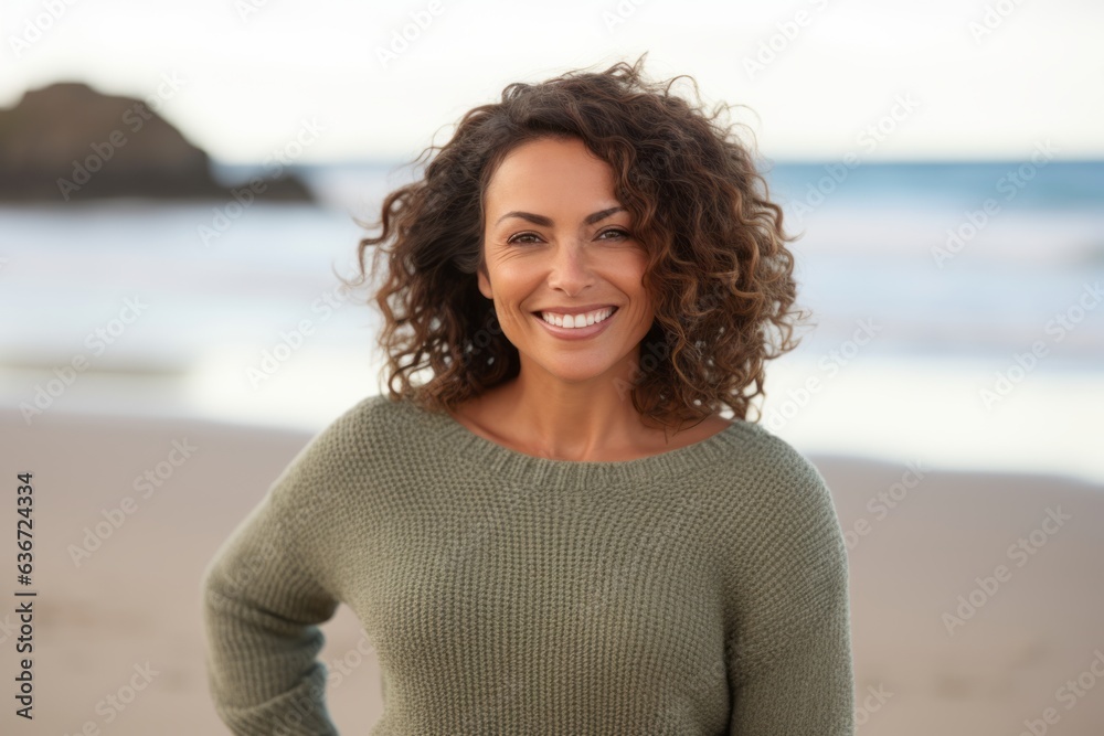 Medium shot portrait of a Brazilian woman in her 40s in a beach background wearing a cozy sweater Medium shot portrait of a Brazilian woman in her 40s in a beach background wearing a cozy sweater