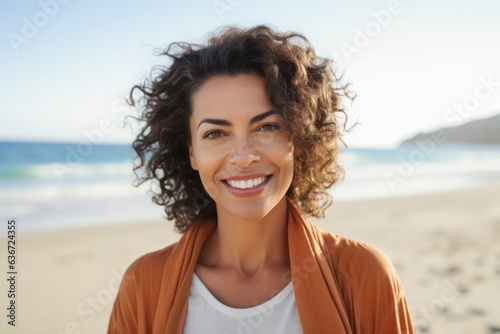 Medium shot portrait of a Brazilian woman in her 40s in a beach background wearing a chic cardigan