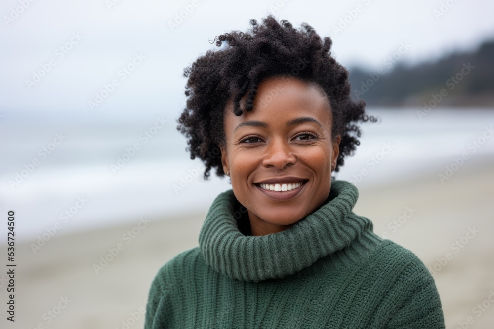 Medium shot portrait of a Nigerian woman in her 30s in a beach background wearing a cozy sweater Medium shot portrait of a Nigerian woman in her 30s in a beach background wearing a cozy sweater