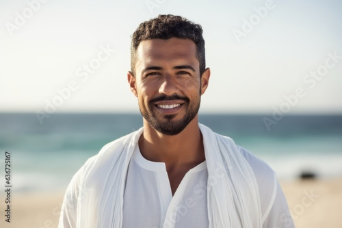 Portrait of smiling man in bathrobe standing at beach on a sunny day