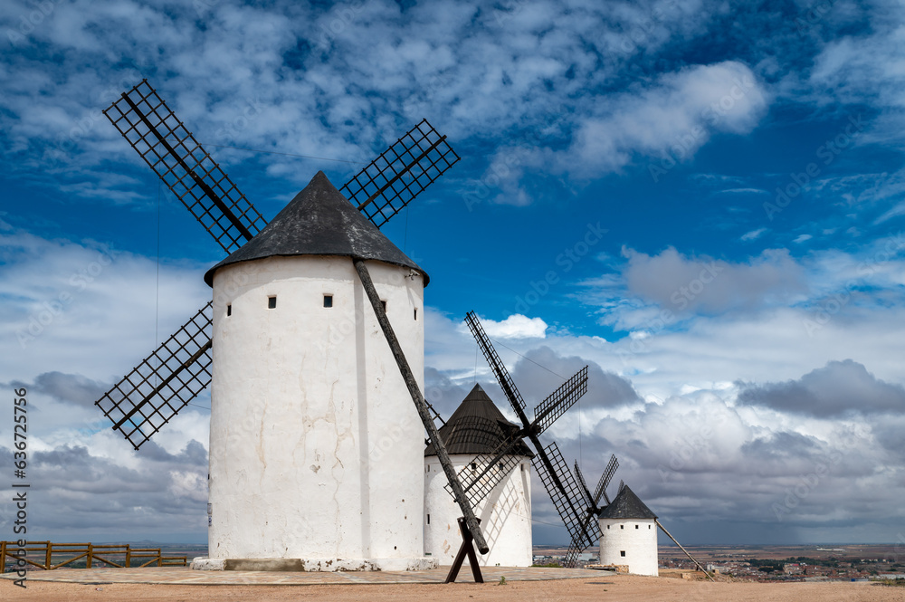 View of the old white stone windmills in Alcazar de San Juan (Spain) in spring