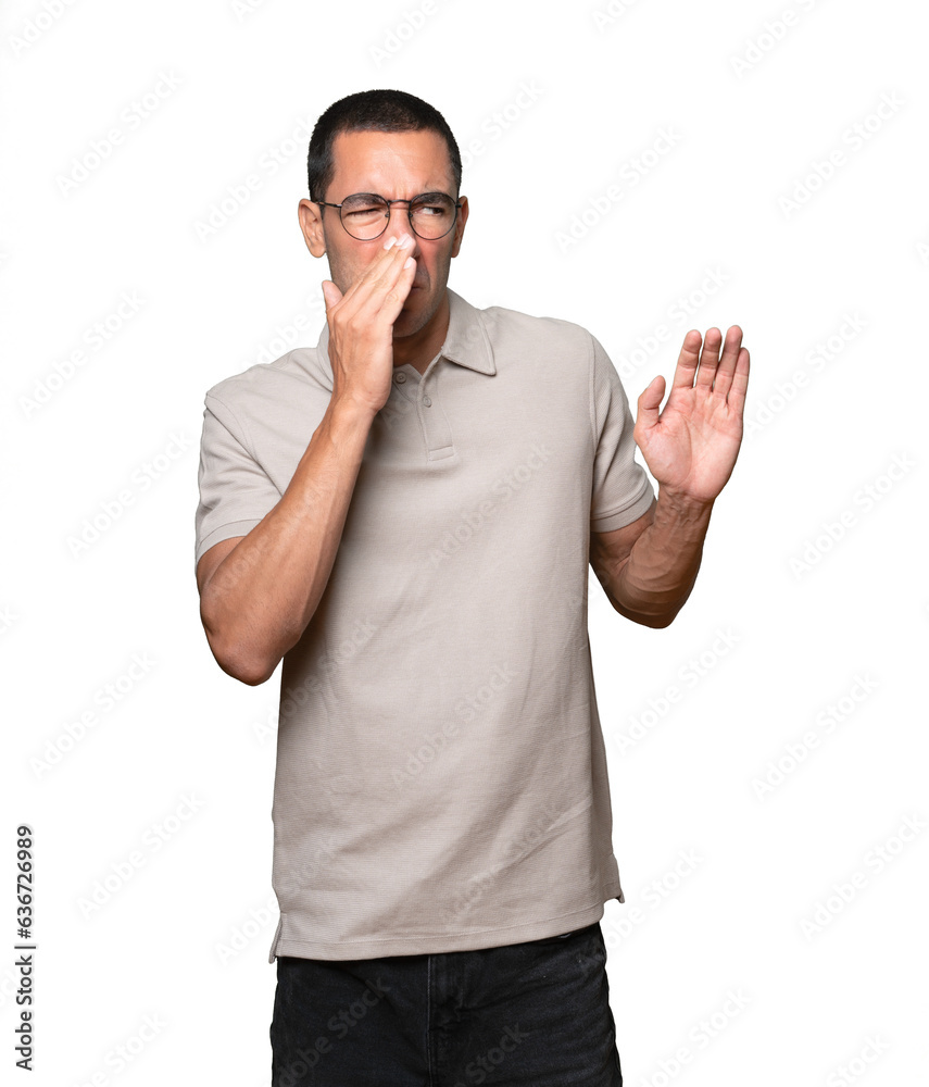Astonished young man with a gesture of shock Astonished young man with a gesture of shock
