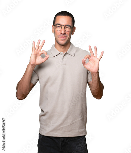 Happy young man doing a gesture of love with his hands