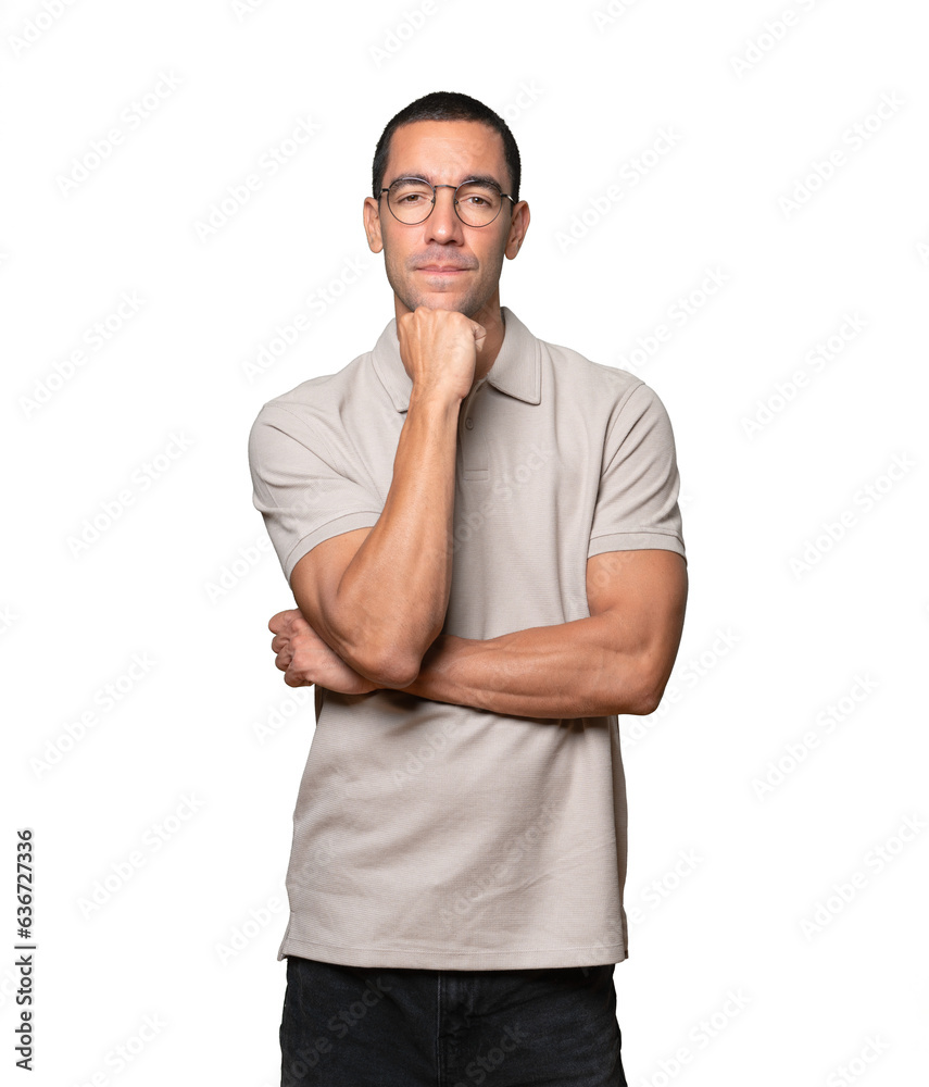 Happy young man smiling and making a gesture of trying to hear something Happy young man smiling and making a gesture of trying to hear something
