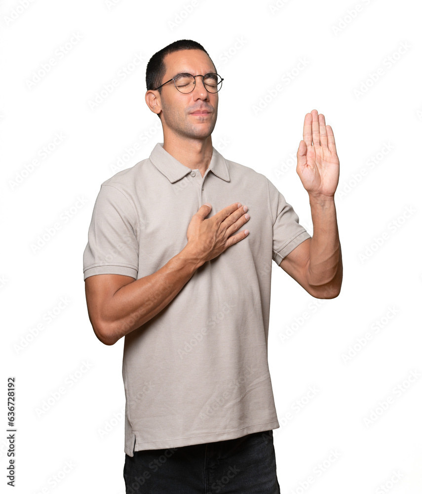 Serious young man with a gesture of oath Serious young man with a gesture of oath