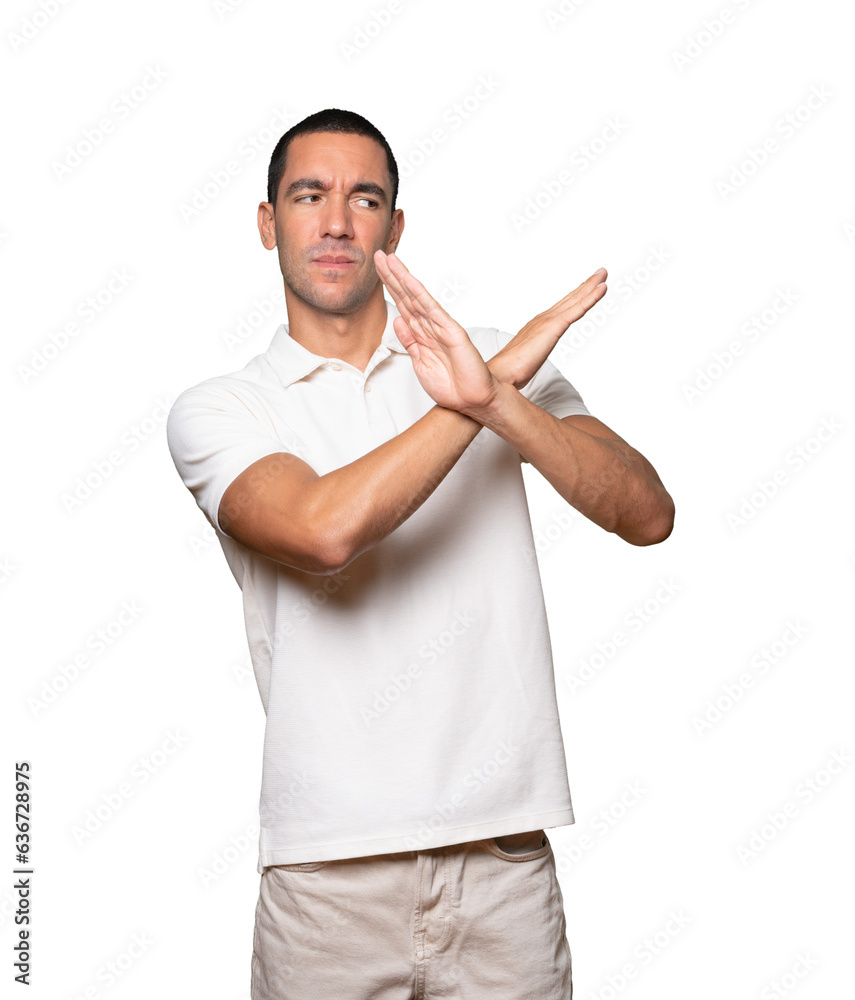 Young man making a gesture of not crossing with the arms Young man making a gesture of not crossing with the arms