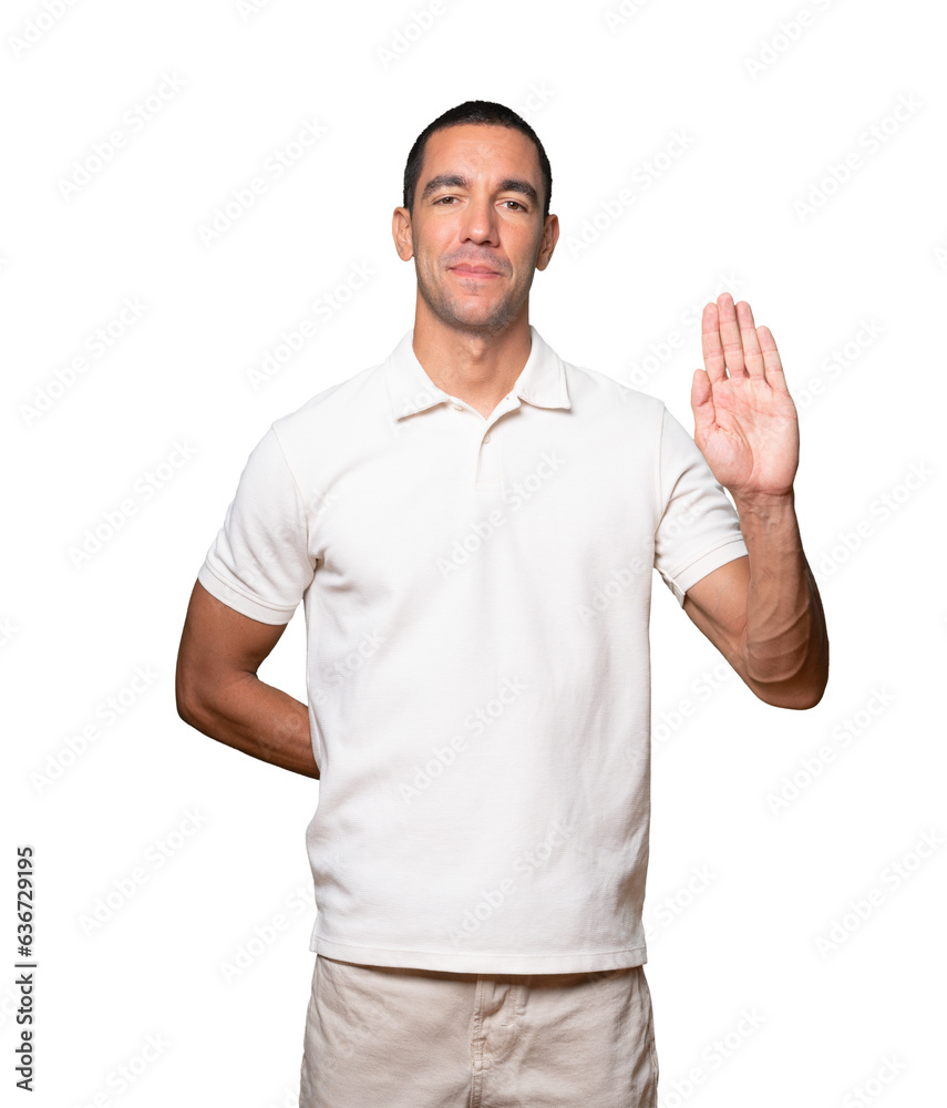 Happy young man making a gesture of stop with his palm Happy young man making a gesture of stop with his palm