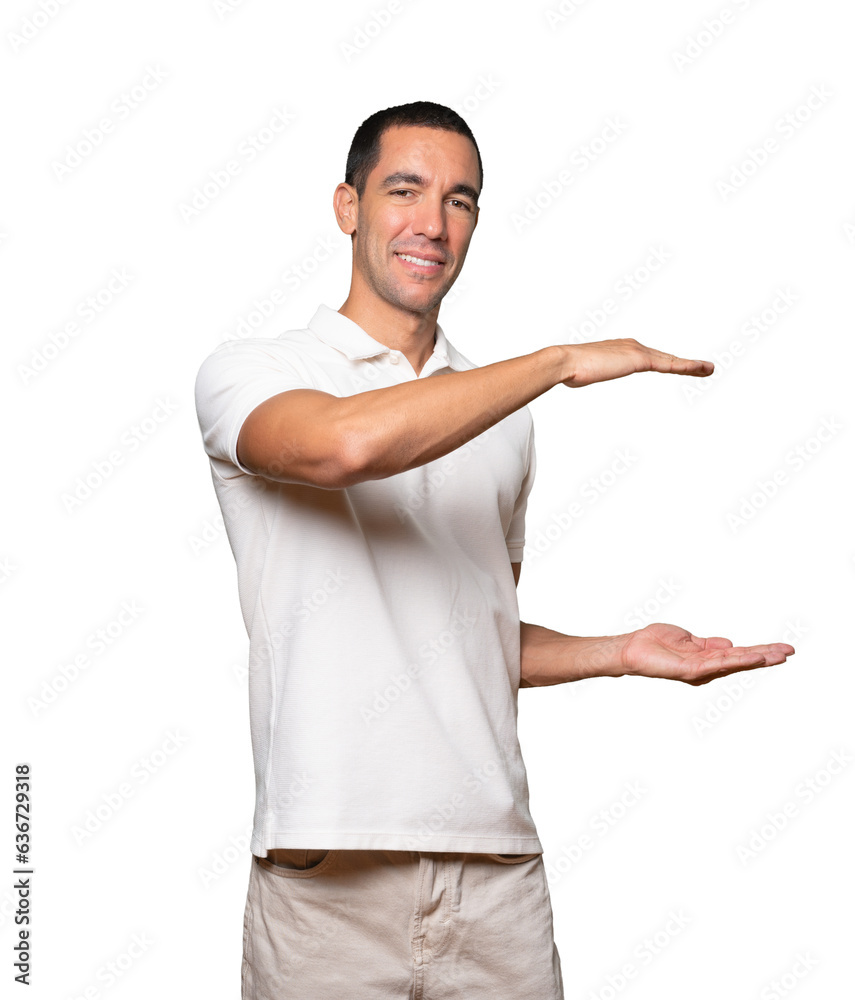 Confident young man doing a gesture of holding something with his hands Confident young man doing a gesture of holding something with his hands