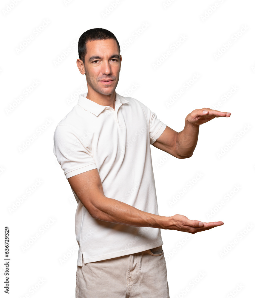 Confident young man doing a gesture of holding something with his hands Confident young man doing a gesture of holding something with his hands
