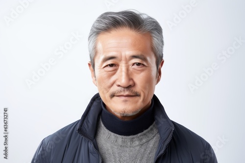 Portrait of a senior asian man with grey hair on white background