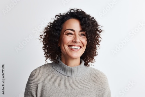 Portrait of a happy young woman with curly hair smiling and looking at camera