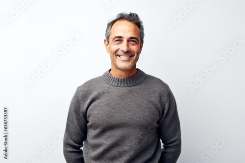 Portrait of a middle-aged man smiling at the camera against white background © Hanne Bauer