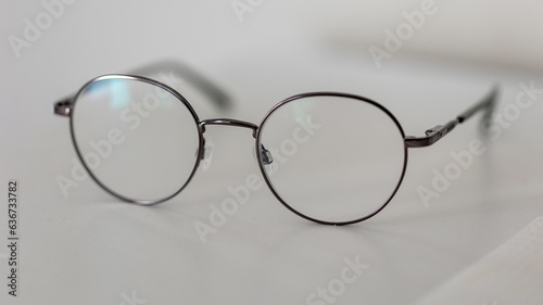 Close-up shot of a pair of eyeglasses on a flat surface