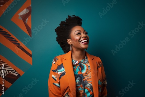 Beautiful african american woman with afro hairstyle in orange jacket on blue background