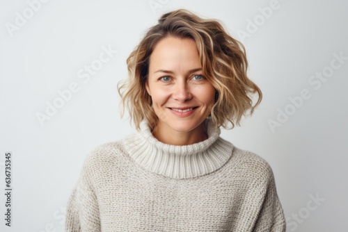 Portrait of a beautiful woman with blond hair in a white sweater