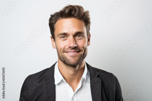 Portrait of a handsome young man smiling at the camera on a white background