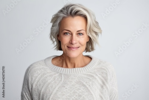 Portrait of beautiful middle-aged woman looking at camera over white background