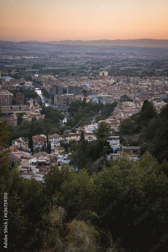 view of the city of granada during sunset with the mountain
