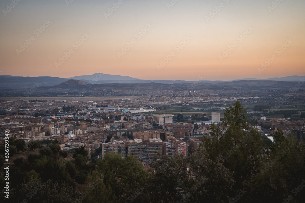 view of the city of granada during sunset with the mountain