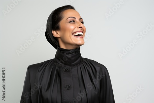 Portrait of a beautiful woman in black hijab smiling and looking up