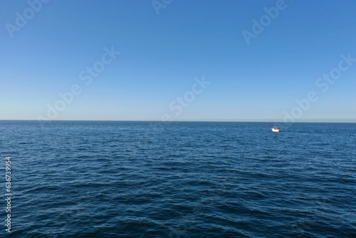 Scenic view of a tranquil bay with a boat floating in the distance