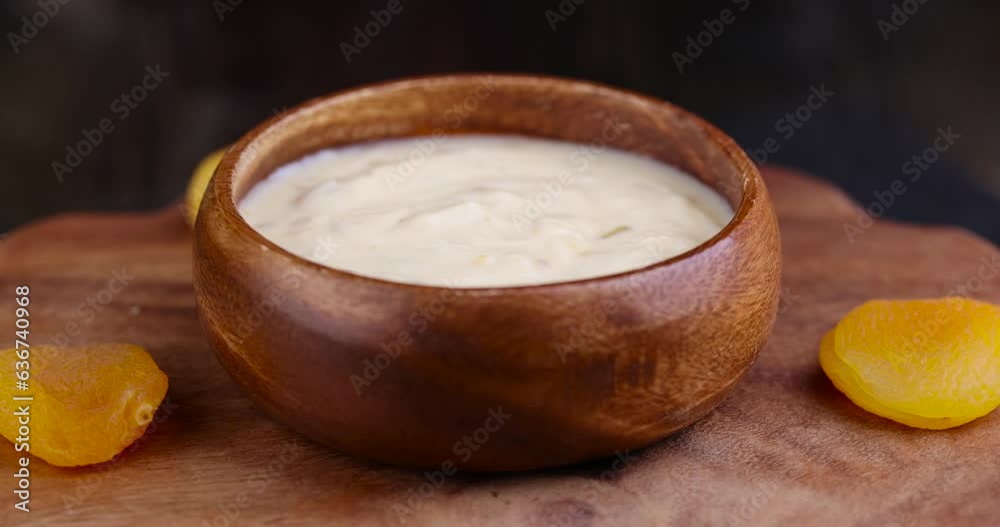 fresh yogurt made from milk with pieces of dried apricots , bio yogurt with the addition of soft dried apricots fresh yogurt made from milk with pieces of dried apricots , bio yogurt with the addition of soft dried apricots