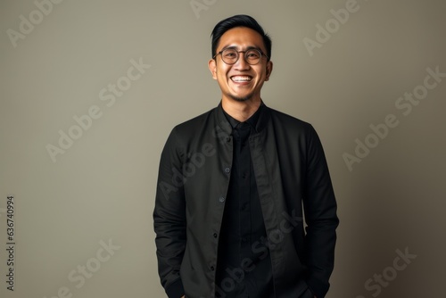 Portrait of a happy young asian man in black shirt and glasses