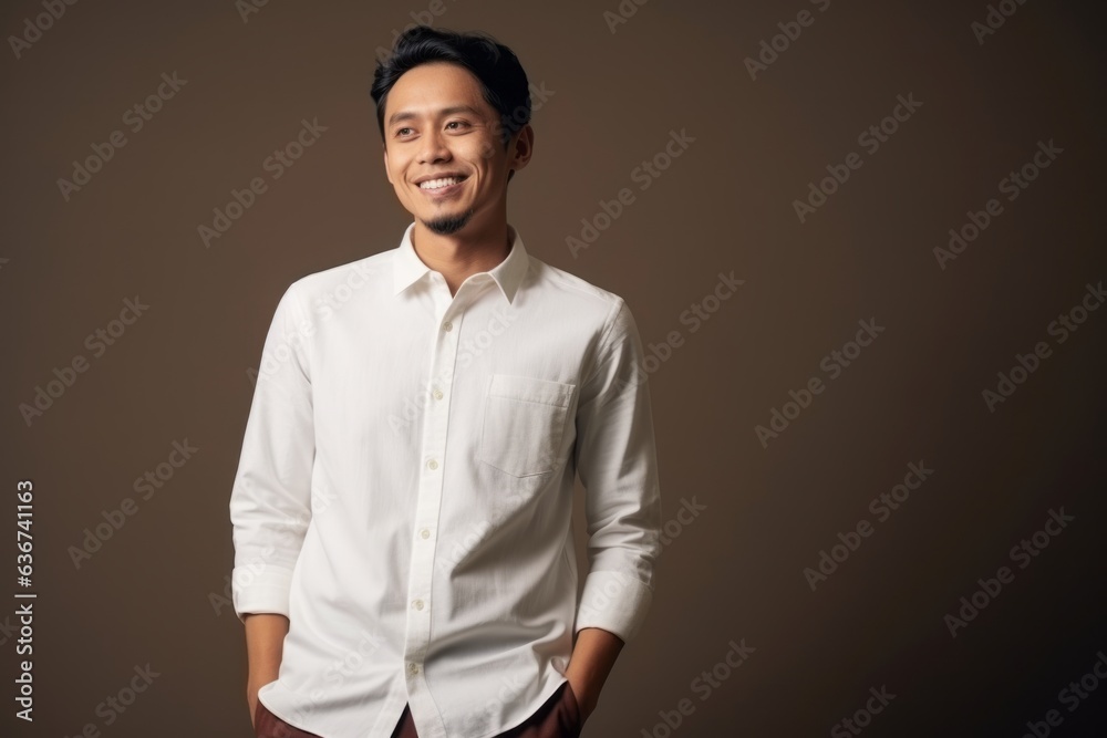 Portrait of a smiling young asian man in a white shirt Portrait of a smiling young asian man in a white shirt